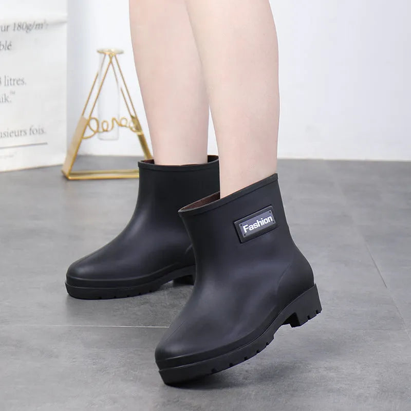 Women's PVC rain boots in black with mid-calf height and low heel design