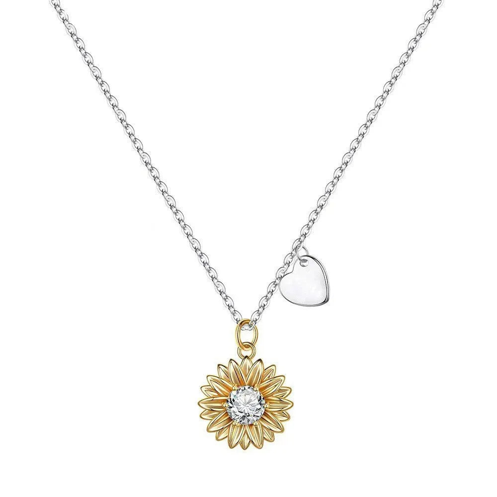 Sterling silver sunflower pendant necklace with adjustable chain on grey background