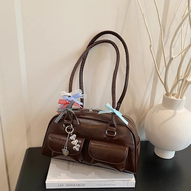 Pillow-shaped PU leather women's handbag in black with ribbon pendant and double shoulder strap