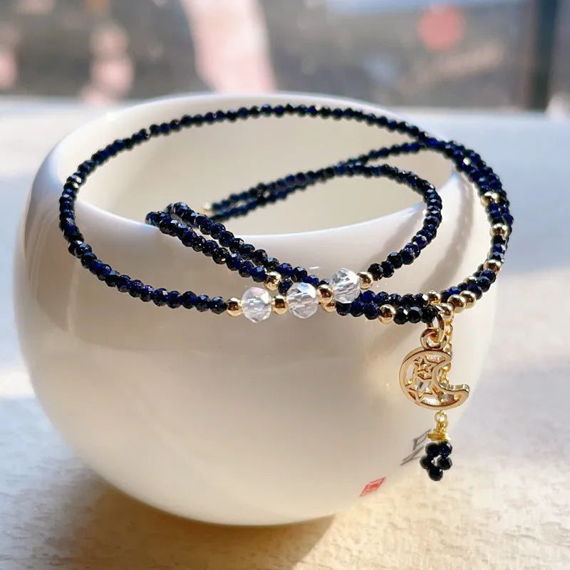 Women's three-ring bracelet with blue sand stone beads in multi-layered gold-tone design