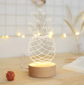 Wood and acrylic pineapple-shaped table lamp with dimmable LED light and USB power cable.