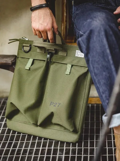 Medium nylon canvas messenger bag in military green with crossbody strap and laptop compartment