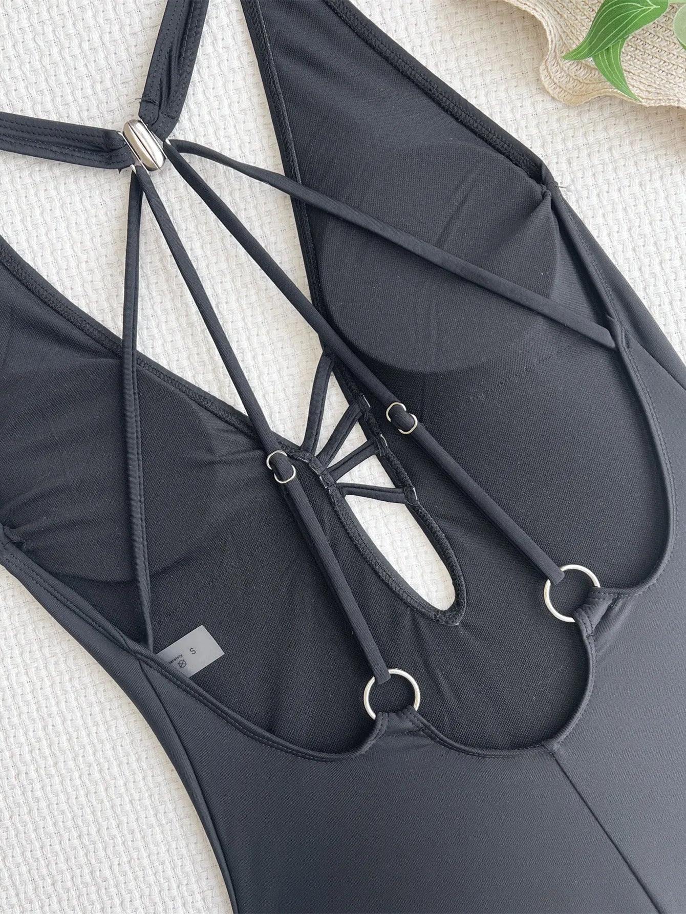 Solid black one-piece swimsuit for women made from nylon fabric.