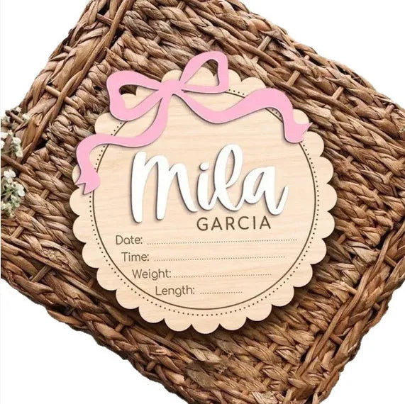 Customisable square wooden baby room ornament with a name, shown in two size options.