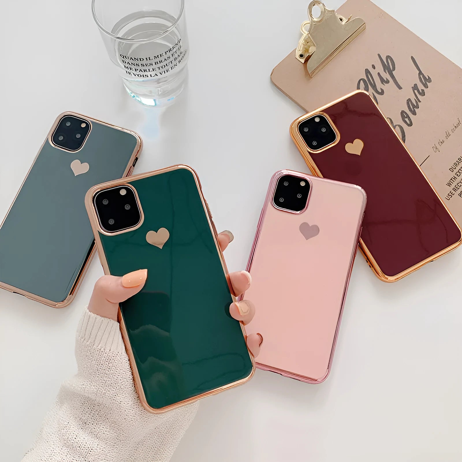 Slim TPU iPhone case in a solid colour with a luxury plating love design, shown fitted to a phone.