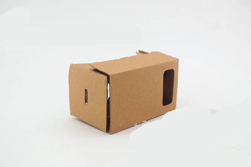 Pink and white foldable VR Cardboard viewer headset for 6-inch smartphones with head strap.