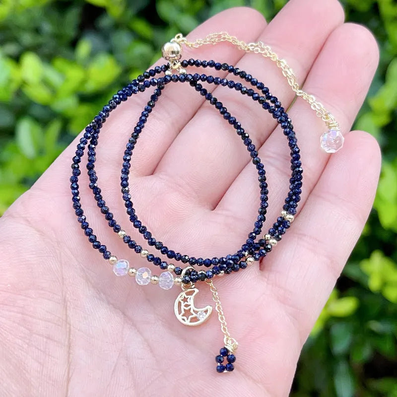 Women's three-ring bracelet with blue sand stone beads in multi-layered gold-tone design
