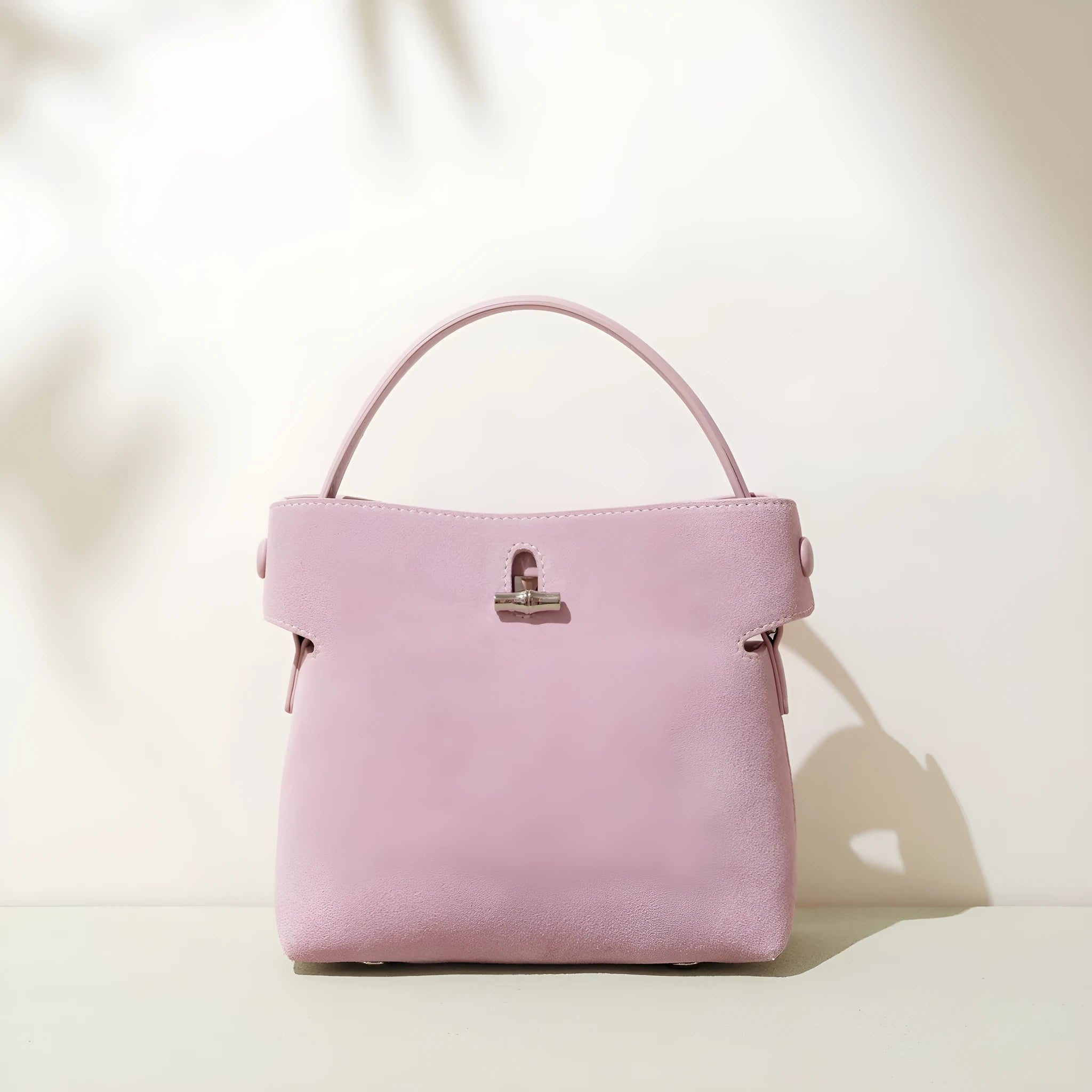 Women's mini messenger bag in matte cowhide with lock closure and bucket shape