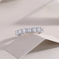 Ferris Wheel moissanite ring set in S925 silver with platinum plating on a white background