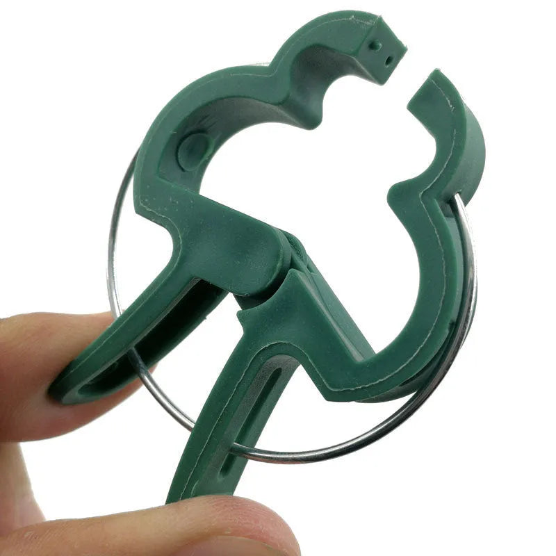 Green plastic and zinc plant fixing clips, showing large and small sizes for supporting climbing vegetables.