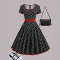 Women's mid-length polka dot dress with square collar, front zip, and pleated skirt