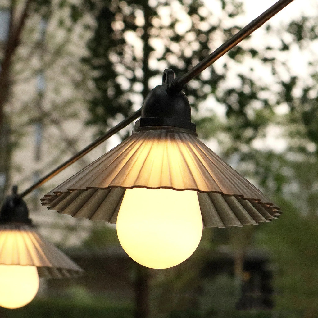 Outdoor LED string lights with flower-shaped coloured globes for garden patio decoration