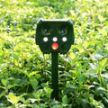 Green solar-powered ultrasonic dog and pest repeller unit for outdoor mounting