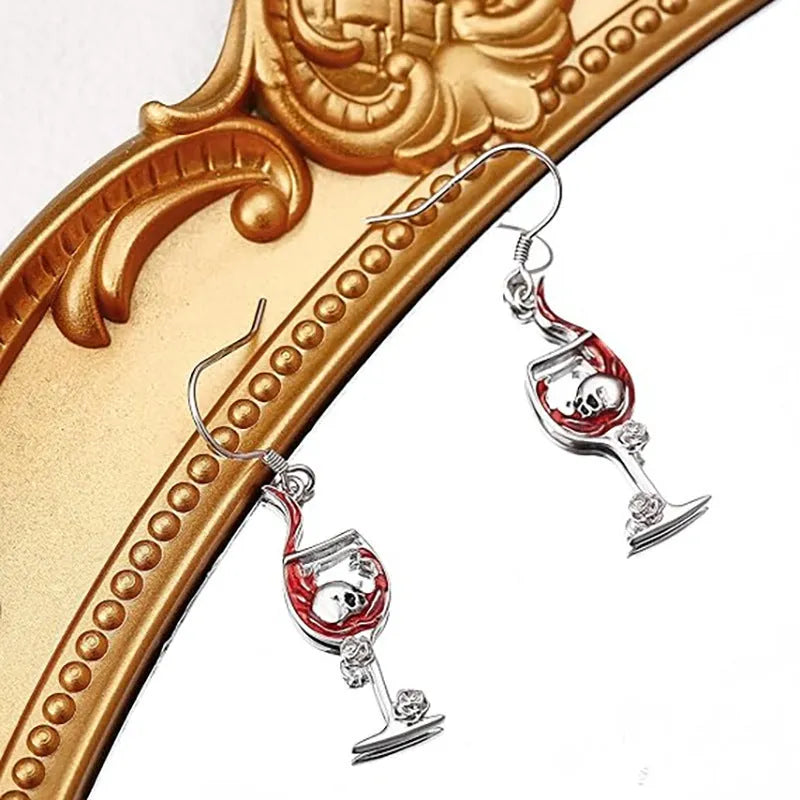 A pair of geometric skull wine glass shaped earrings with an electroplated finish.