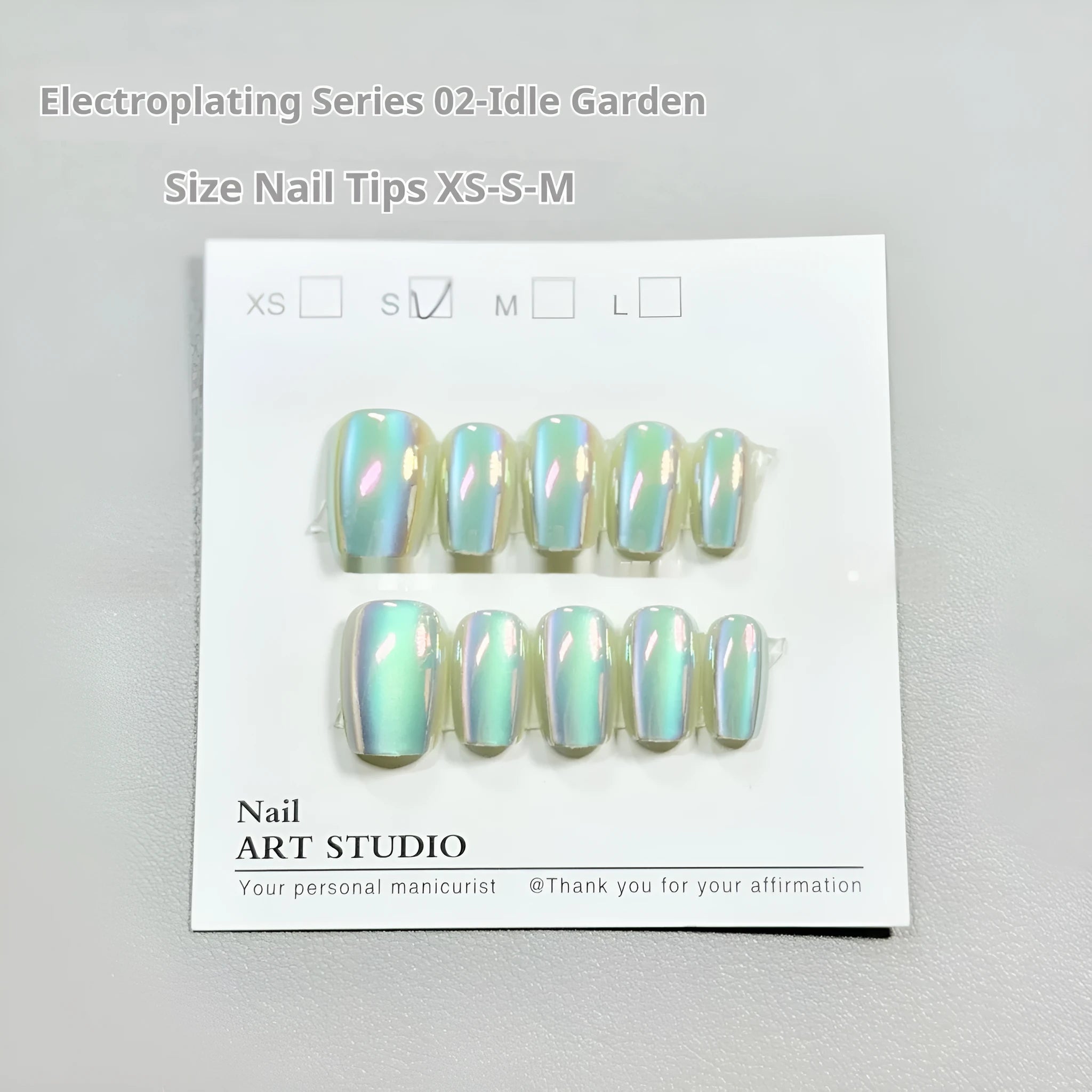 Electroplated Cat's Eye press-on nails in short ladder shapes with XS, S, and M sizes showing Aurora and solid colour designs