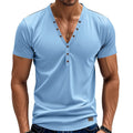 Man wearing a loose fit light blue V-neck button-up sport shirt