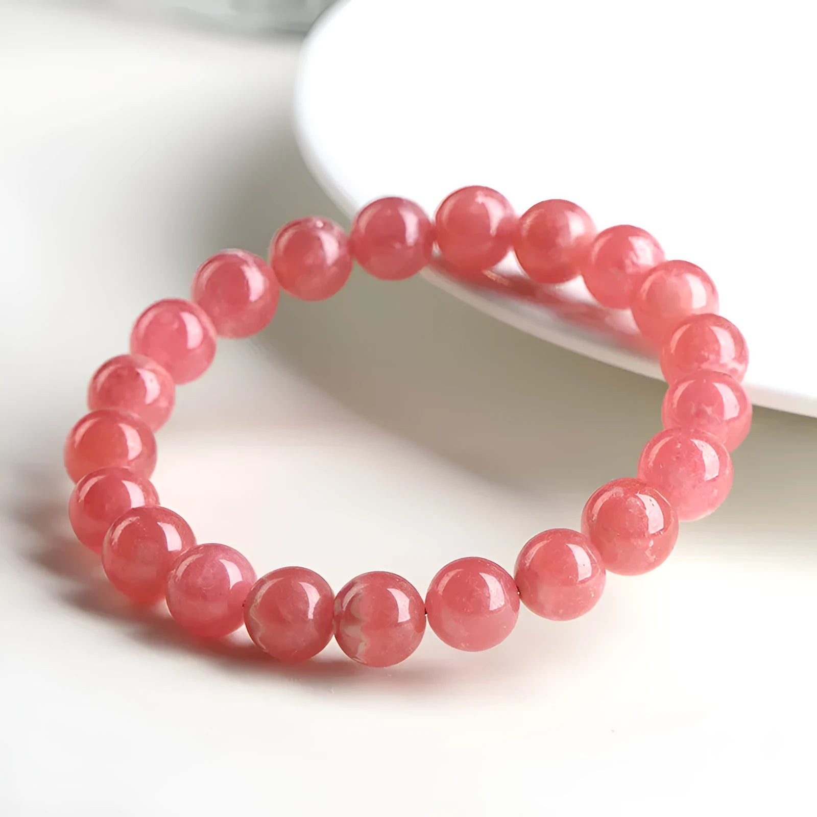 Women's geometric crystal bracelet with rhodochrosite stone and longevity lock in natural red patterns