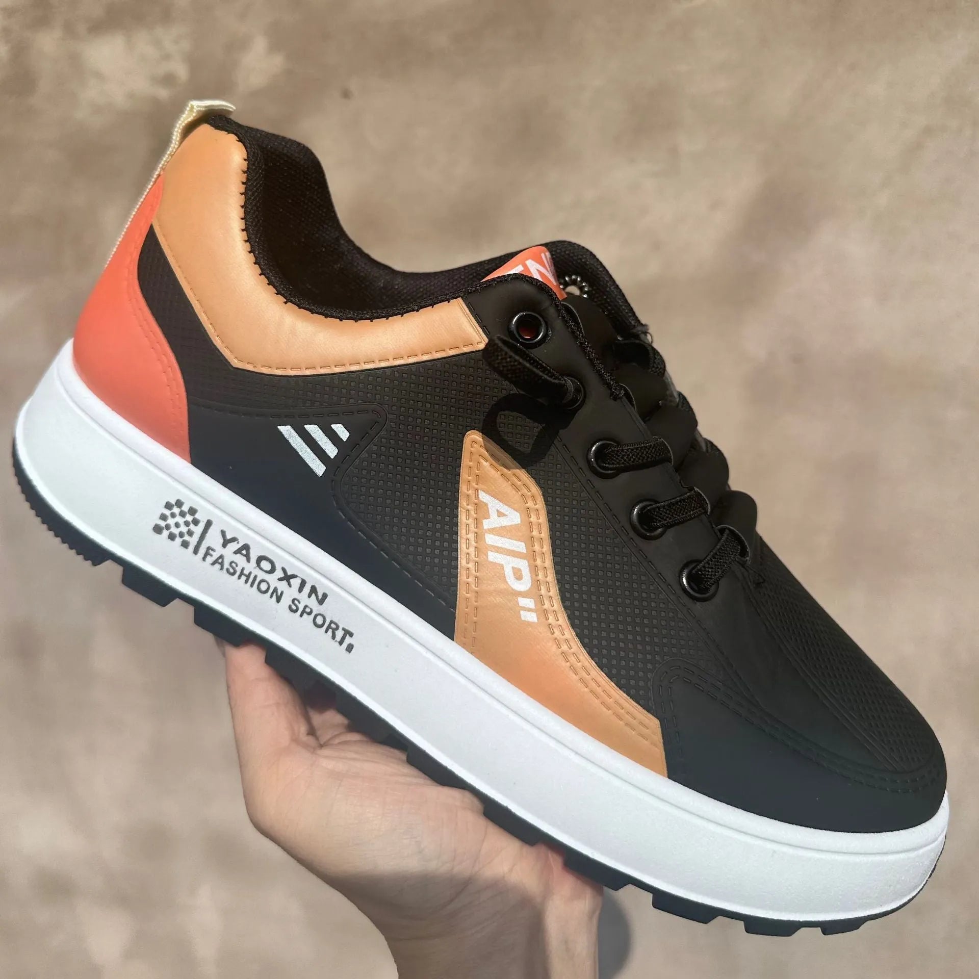 Men's white and orange casual sneakers with round toe and PU upper, shown alongside black and brown colour options.