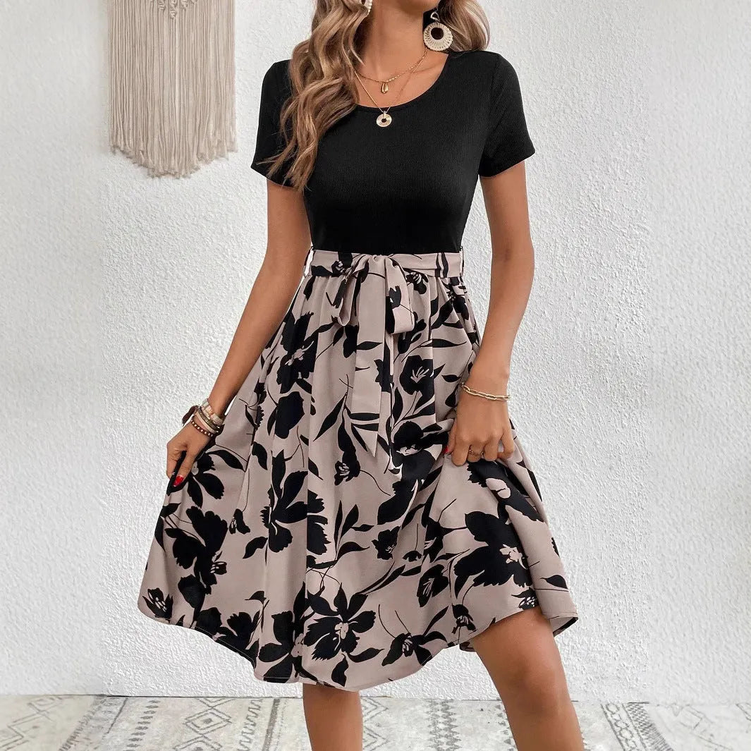 Khaki floral print women's dress with lace-up detail and A-line skirt on a hanger