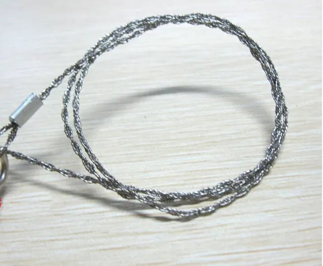 Stainless steel survival wire saw with pull rings, 55cm blade for outdoor wood cutting.