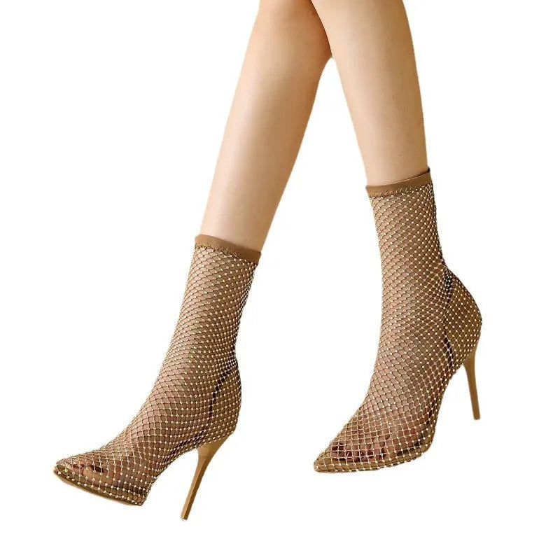 Gold high heel sandals with mesh upper, pointed stiletto toe, and an oversleeve design.