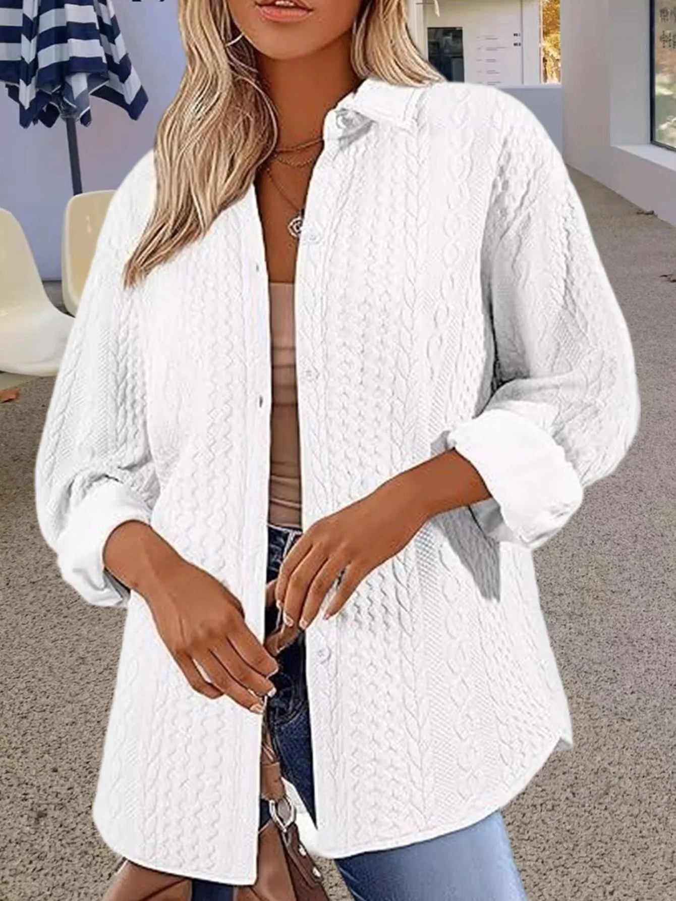 Women's knitted polyester cardigan sweater in black, shown on a hanger.