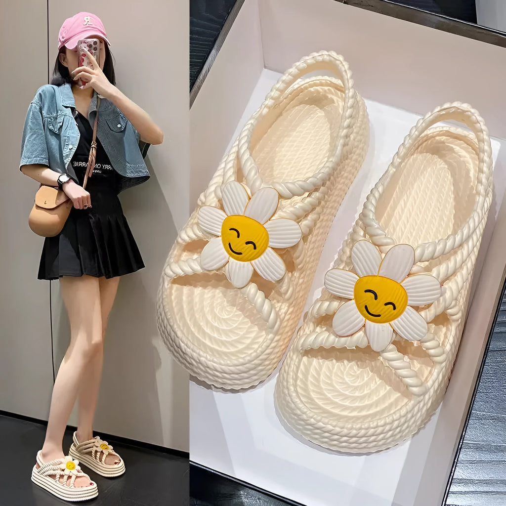 Beige PVC sandals with a round toe, sunflower design, and non-slip sole.