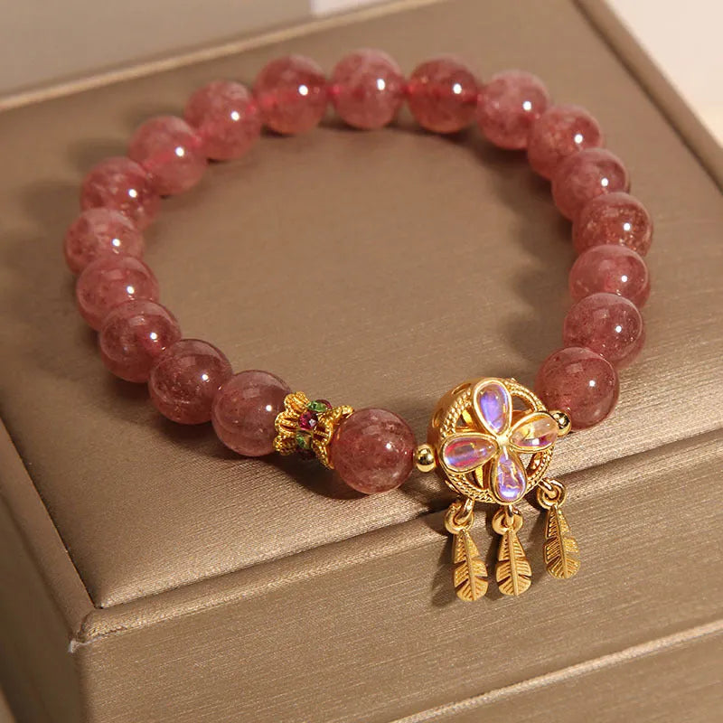 Women's strawberry quartz bracelet with four-leaf dream catcher ball pendant, original crystal jewellery design