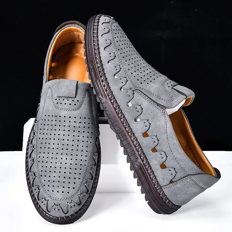 Men's brown slip-on casual leather shoes with round toe and flat PVC sole on a white background.