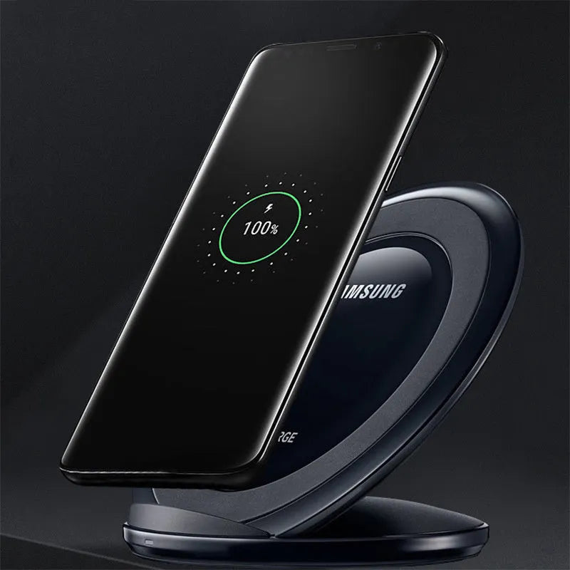 Black Qi wireless charging pad for Samsung Galaxy Note Edge on a wooden surface