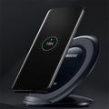 Black Qi wireless charging pad for Samsung Galaxy Note Edge on a wooden surface