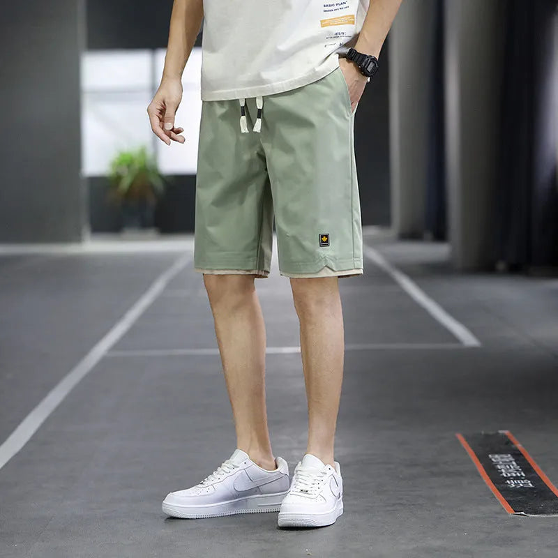 Loose straight-leg polyester beach shorts with elastic waist in multiple colour options