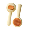 Green stainless steel cat grooming brush with non-slip handle removing loose pet hair