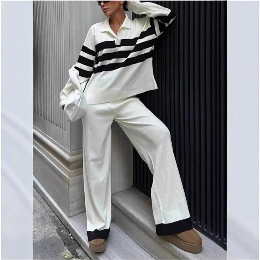 Women's black and white striped knitted polo shirt and trouser two-piece set.