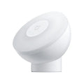 White square modern bedside table lamp with motion sensor and Bluetooth, shown on a nightstand.