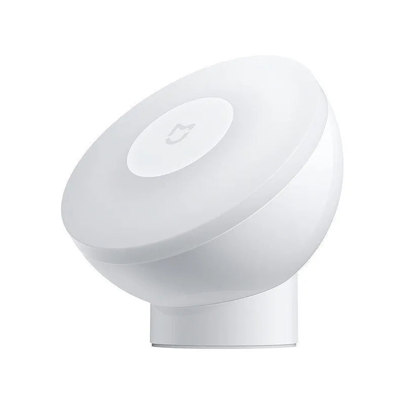 White square modern bedside table lamp with motion sensor and Bluetooth, shown on a nightstand.