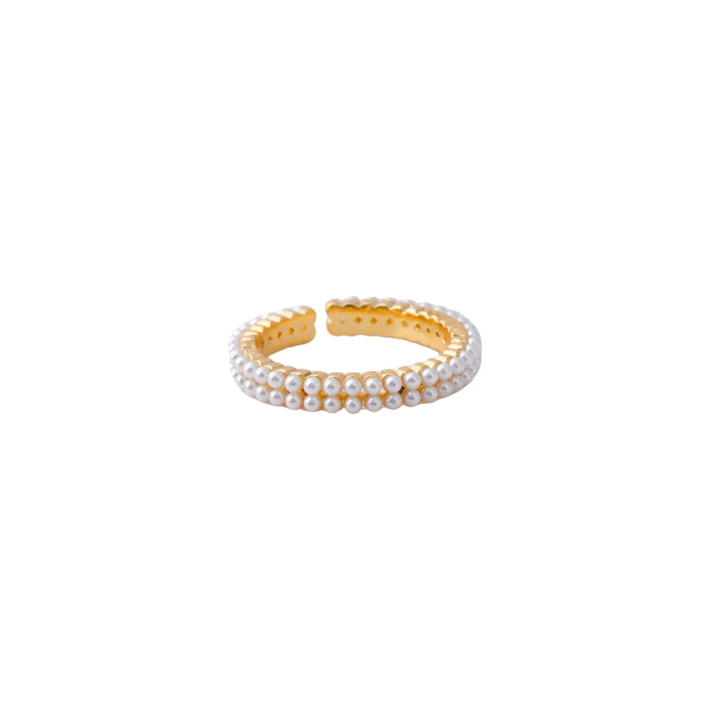 Gold geometric open ring for women with round pearls on a white background.