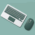 Pink mute wireless Bluetooth touch keyboard and rechargeable mouse set on a desk.