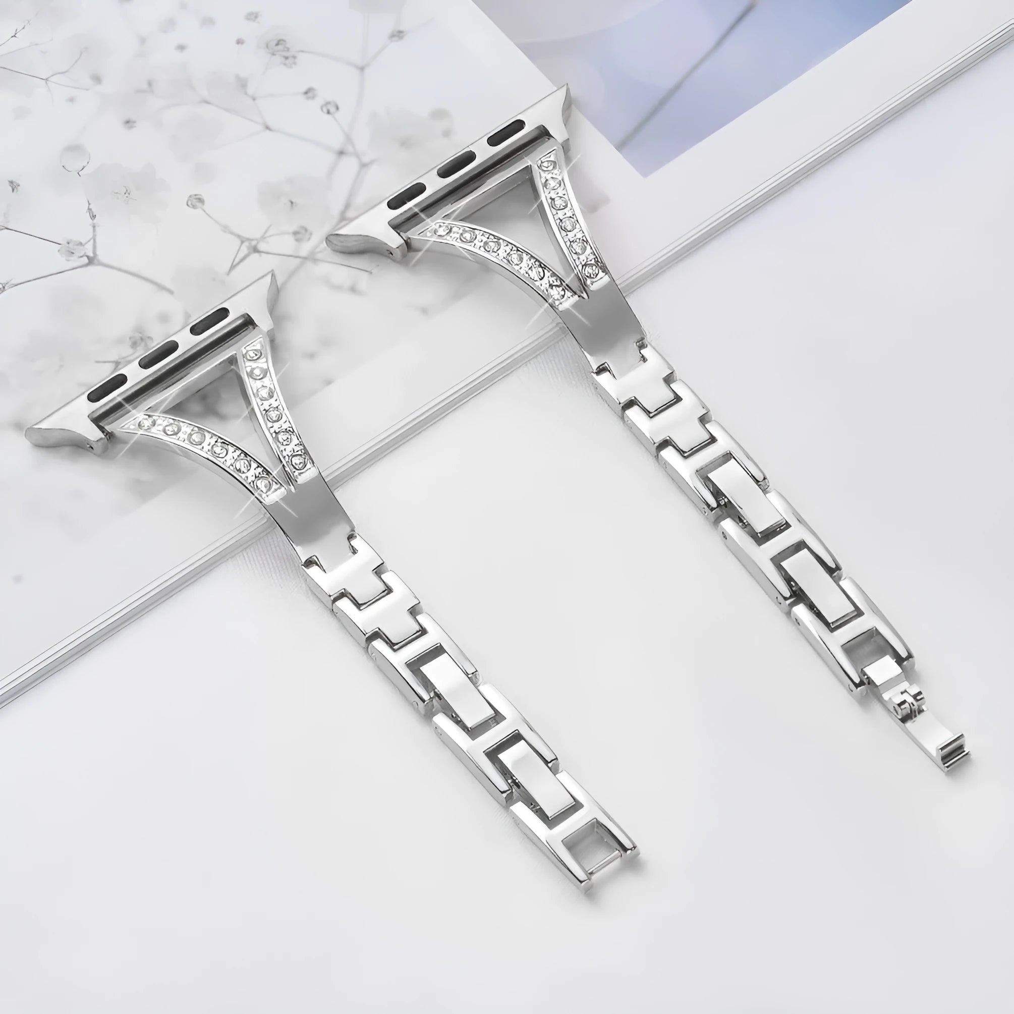 Silver herringbone diamond pattern metal strap for Apple Watch, showing adjustable links and connector lugs.