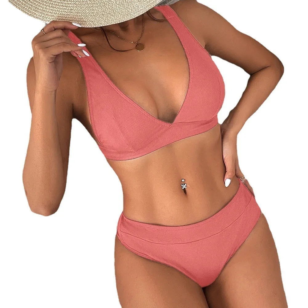 Women's black bikini with lace-up front detail and high-leg split style on a mannequin.