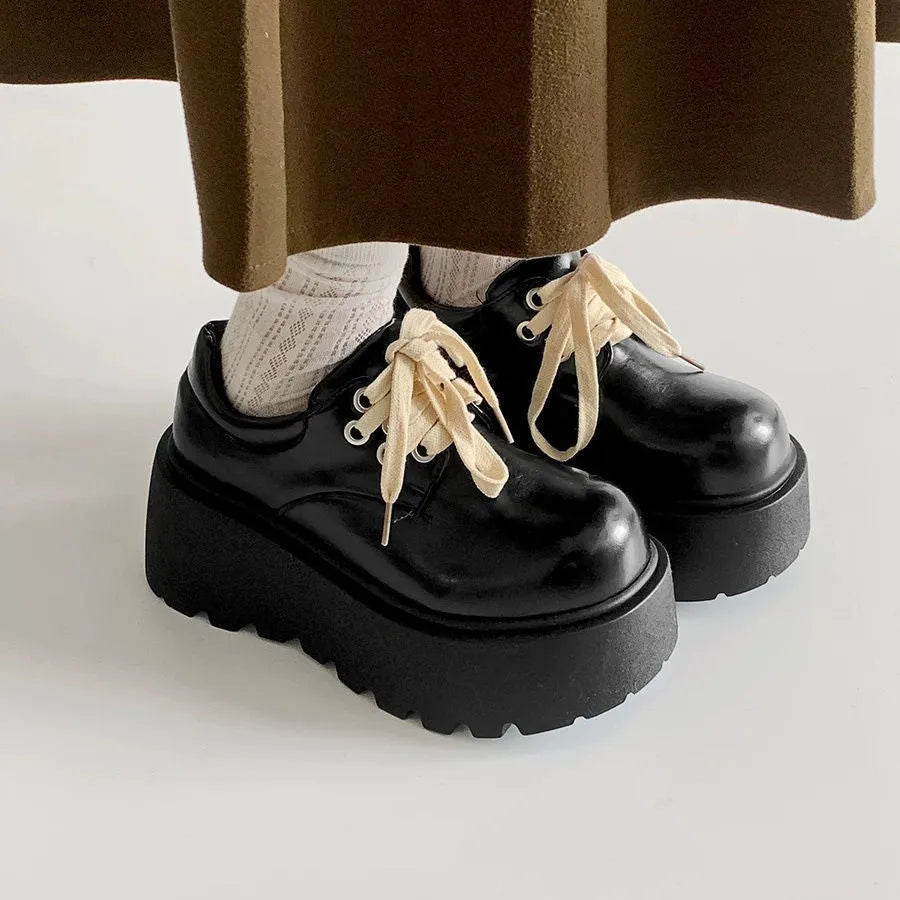 Matte black women's lace-up platform heels with chunky 6-8cm sole and round toe.