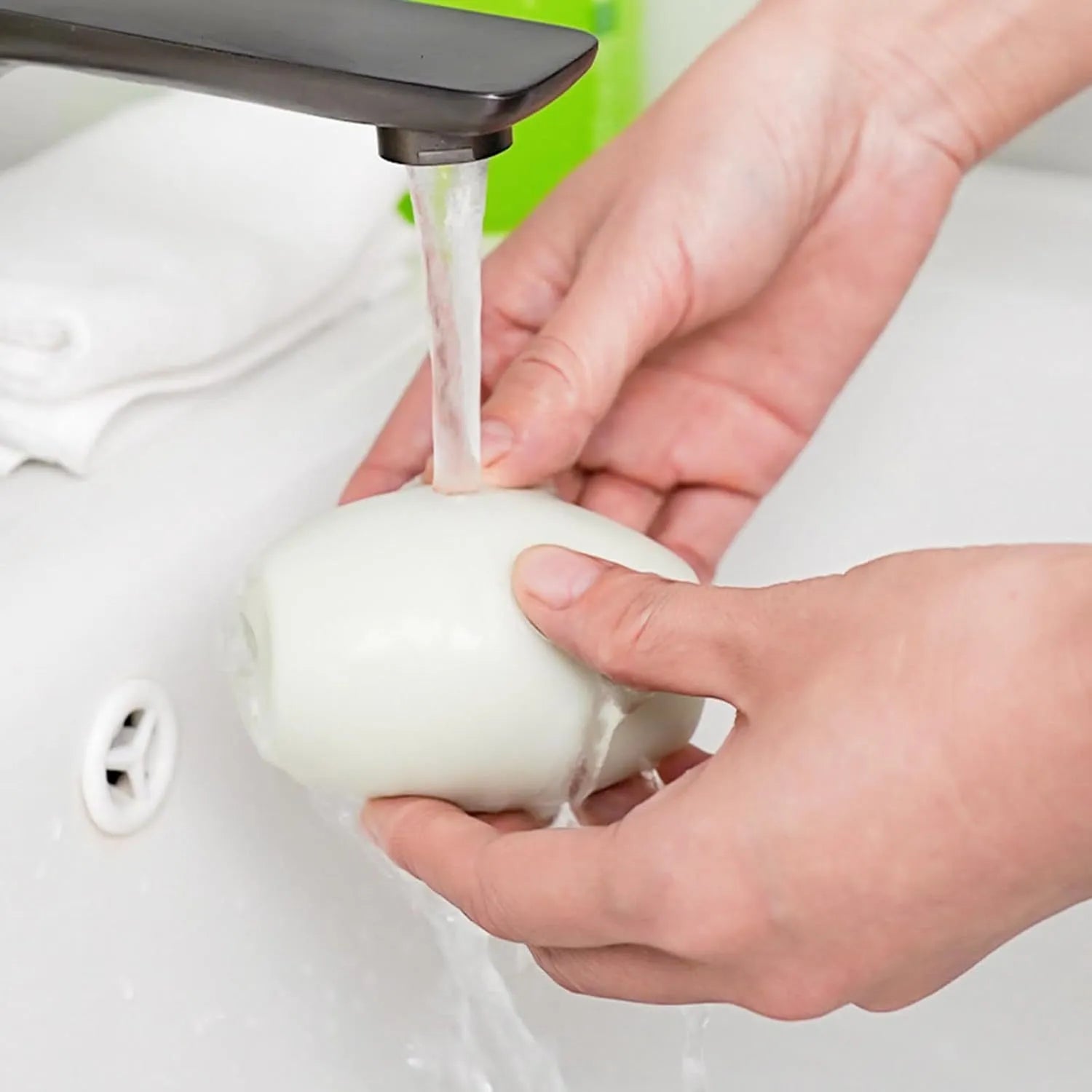 Green and white washable gel lint roller balls for pet hair removal on fabrics