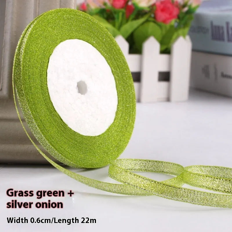 Roll of 0.6cm wide coloured polyester ribbon in onion-dye shades for clothing and gift packaging
