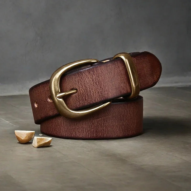 Men's black genuine leather casual belt with a copper pin buckle on a jeans background.