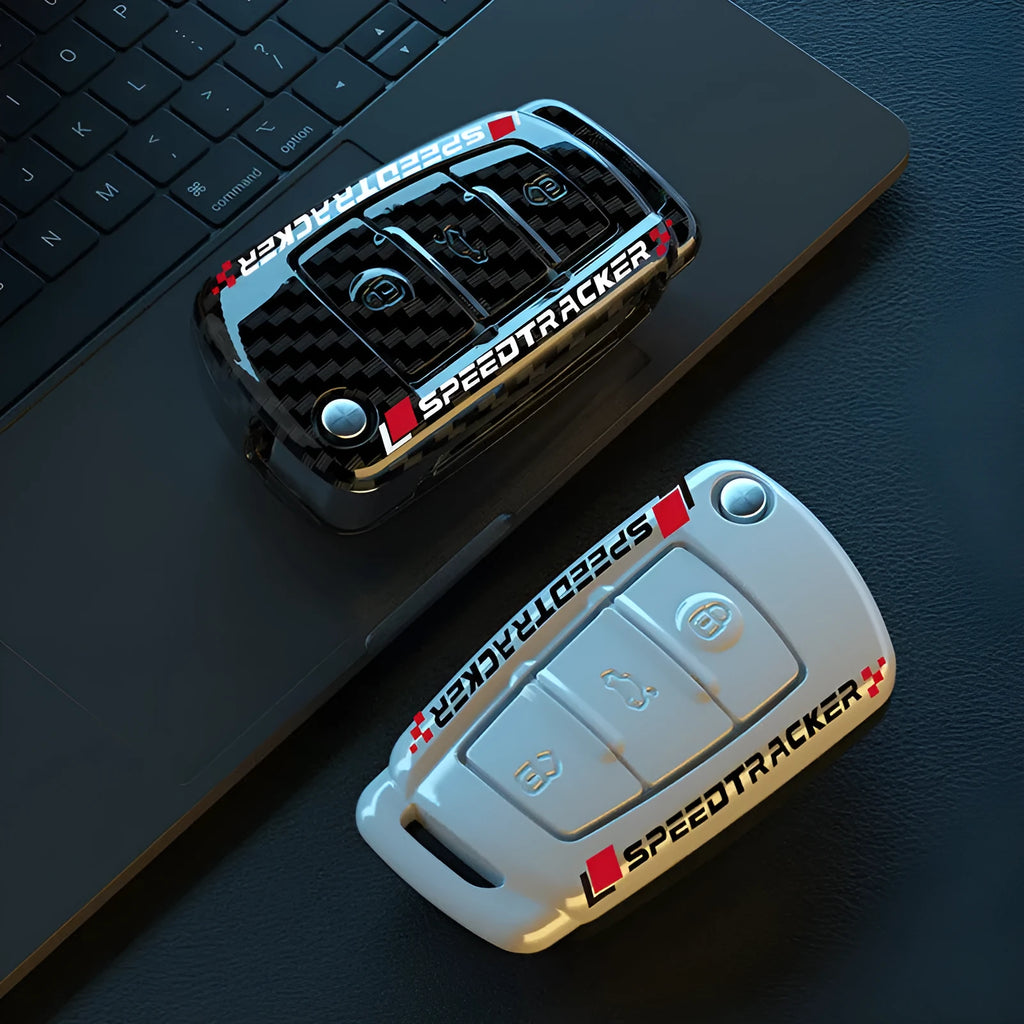 Carbon fibre pattern car key cover with a small rectangular mirror set into the feilin material casing.