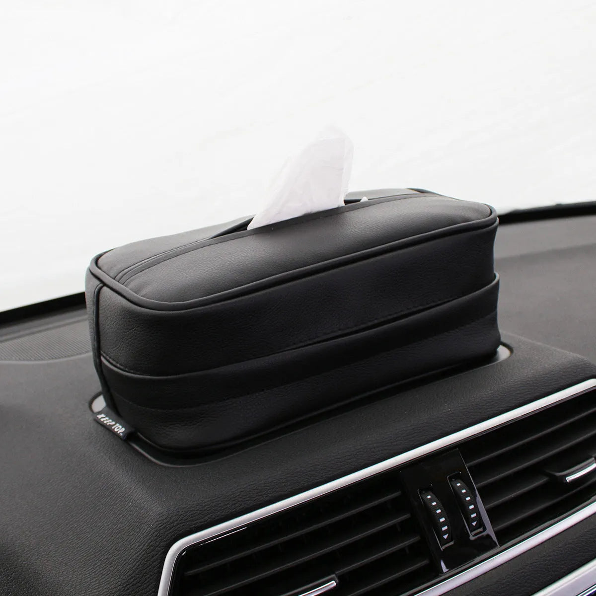 Black PU leather hanging storage box with paper bag liner, shown suspended.