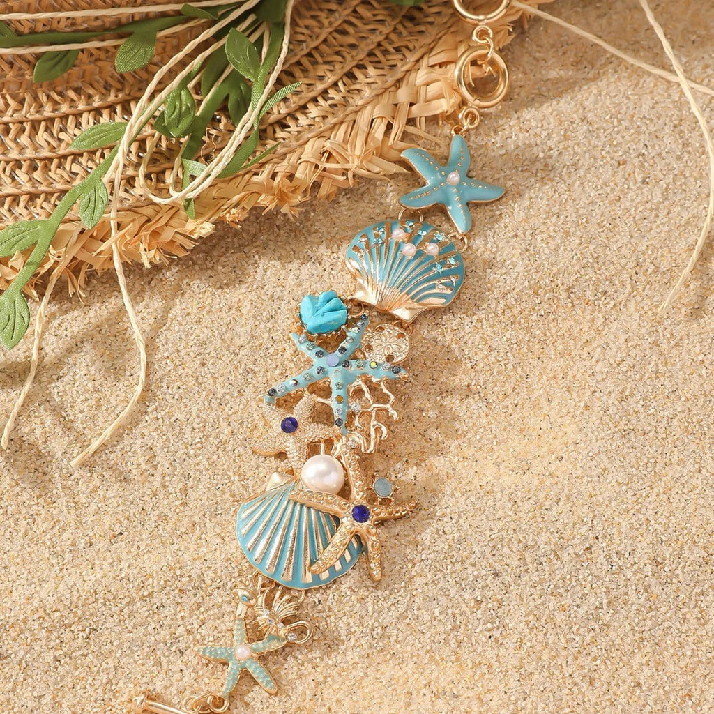 Alloy nautical bracelet with starfish, marine shell and boat anchor charms in turquoise colour