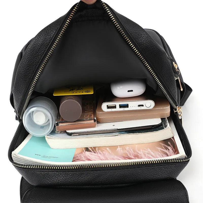Women's leather backpack with textured material and three-dimensional pockets in street style
