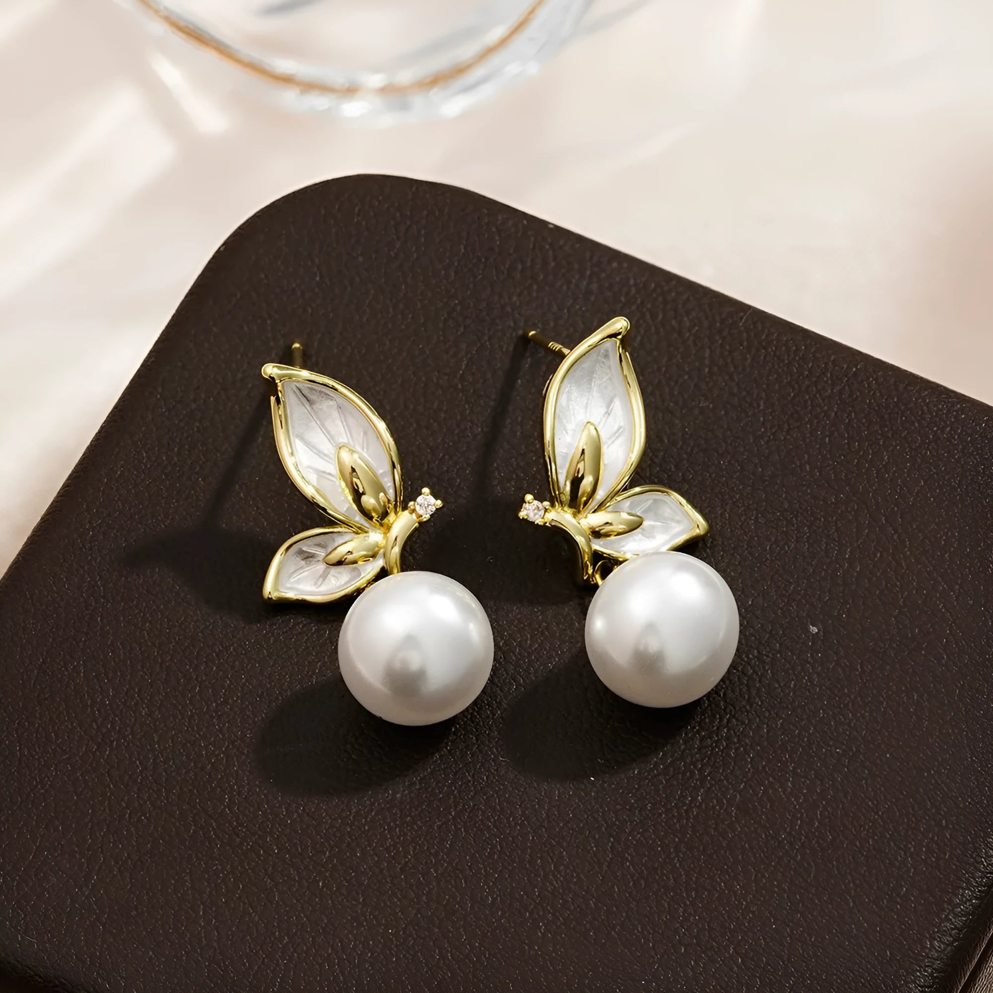 A pair of women's butterfly earrings in colour PT0203, made from copper with zircon painting.