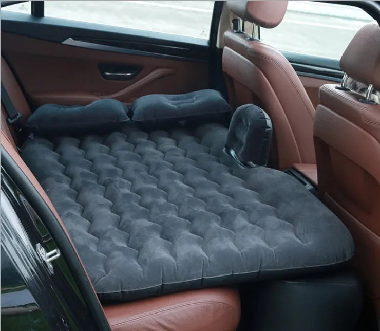Black inflatable car bed with flocked surface, two pillows, and storage bag for five-seater vehicles